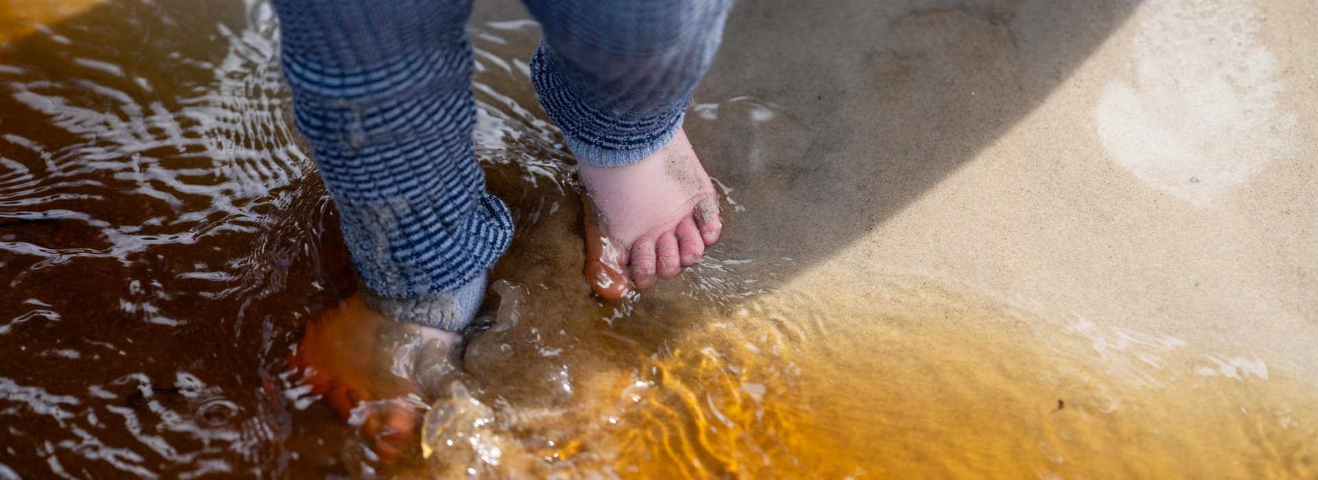 Child with feet in water